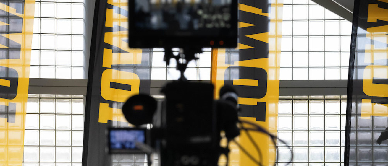 Video camera in front of Iowa banners